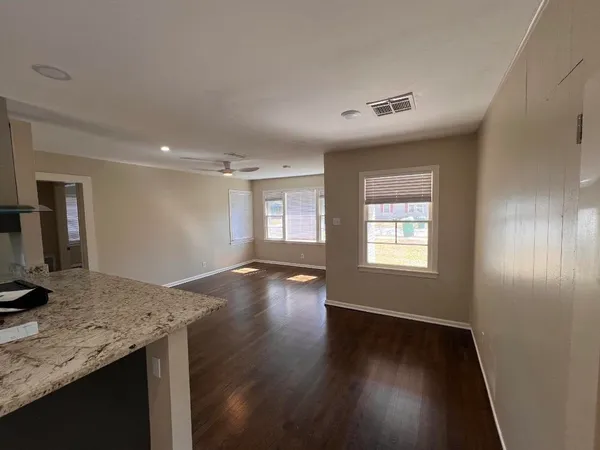 a view of a kitchen cabinets a stove and wooden floor