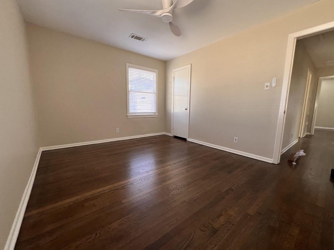 5834 Indigo Street Houston, TX 77074 - Photo 4 of 15 an empty room with wooden floor and windows
