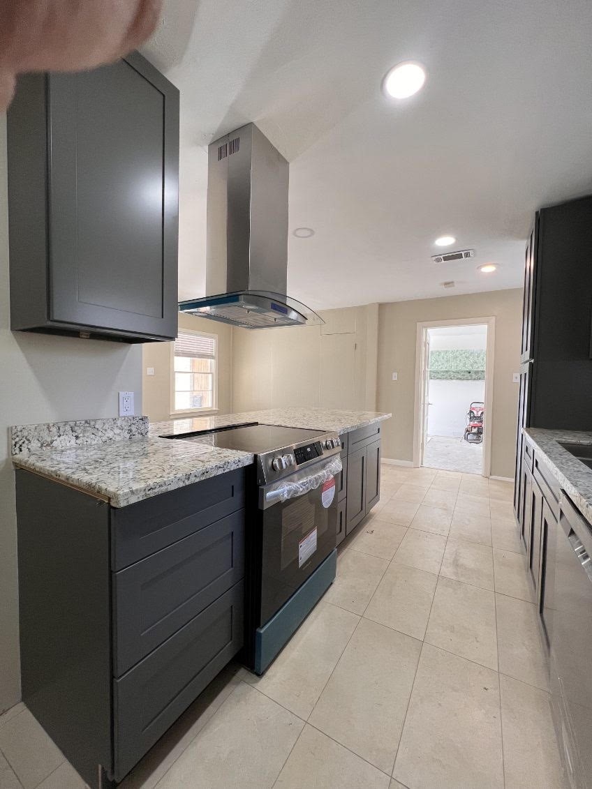 5834 Indigo Street Houston, TX 77074 - Photo 9 of 15 a kitchen with stainless steel appliances granite countertop a sink and a stove