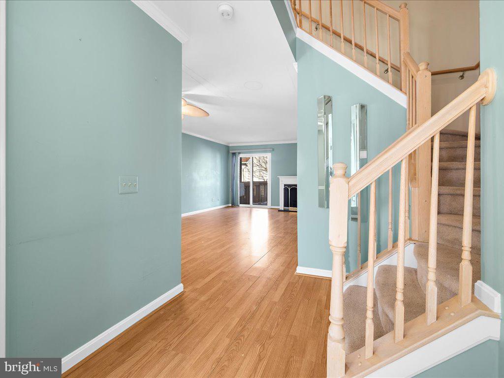 266 St Michaels Circle Odenton, MD 21113 - Photo 13 of 42 a view of a hallway with wooden floor and stairs