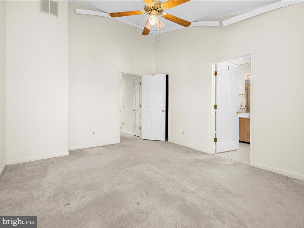 266 St Michaels Circle Odenton, MD 21113 - Photo 30 of 42 an empty room with chandelier fan and windows