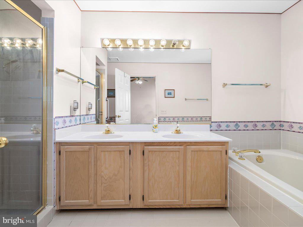 266 St Michaels Circle Odenton, MD 21113 - Photo 32 of 42 a bathroom with a sink a mirror and a bathtub