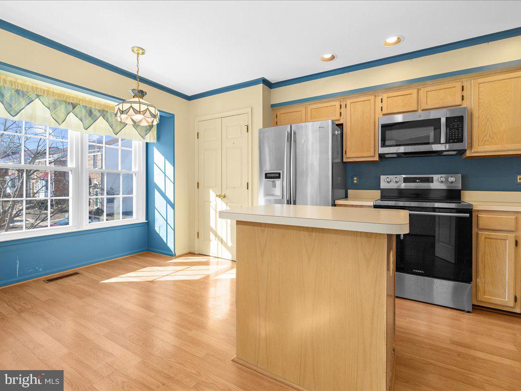 266 St Michaels Circle Odenton, MD 21113 - Photo 8 of 42 a kitchen with stainless steel appliances a stove cabinets and wooden floor