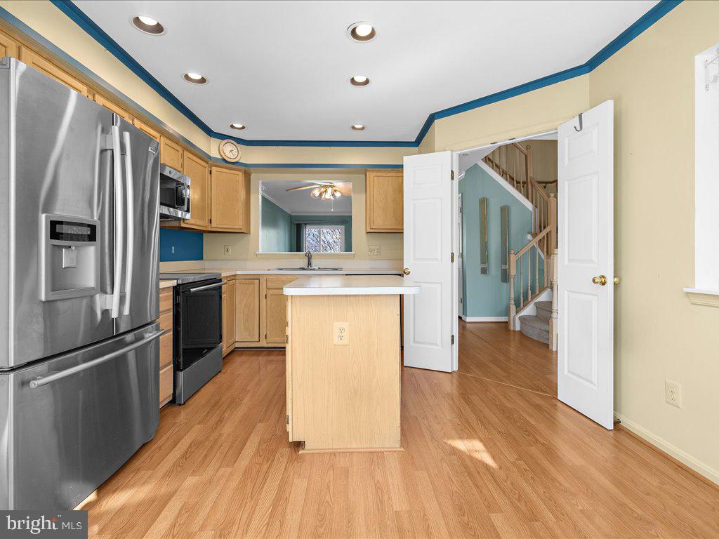 266 St Michaels Circle Odenton, MD 21113 - Photo 10 of 42 a kitchen with stainless steel appliances granite countertop a refrigerator a sink and white cabinets with wooden floor