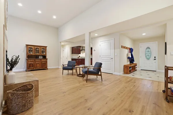 a living room with furniture a clock and a fireplace