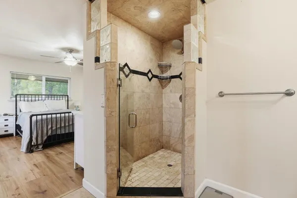 a bedroom with a bed and a chandelier