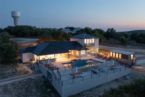 an outdoor space with swimming pool and outdoor seating