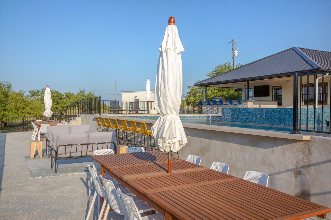 171 Hart Lane Dripping Springs, TX 78620 - Photo 11 of 40 a roof deck with table and chairs