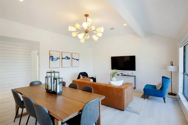 a view of a dining room with furniture and a flat screen tv