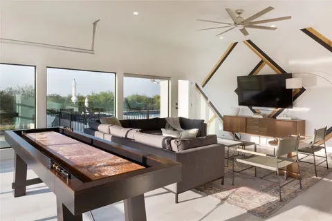 a living room with patio furniture and a flat screen tv