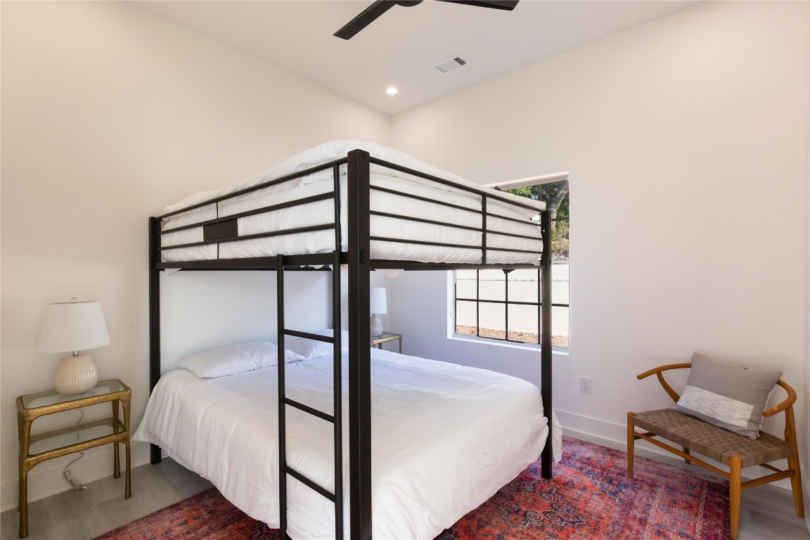 171 Hart Lane Dripping Springs, TX 78620 - Photo 19 of 40 a bedroom with a bed and a window