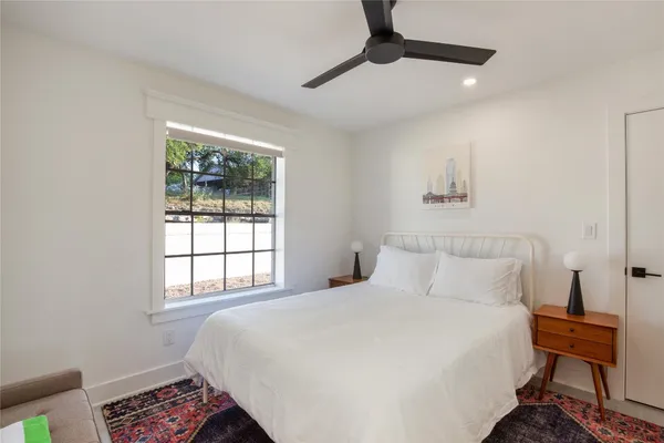 a bedroom with a bed and a window