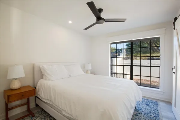 a bedroom with a large bed and a window