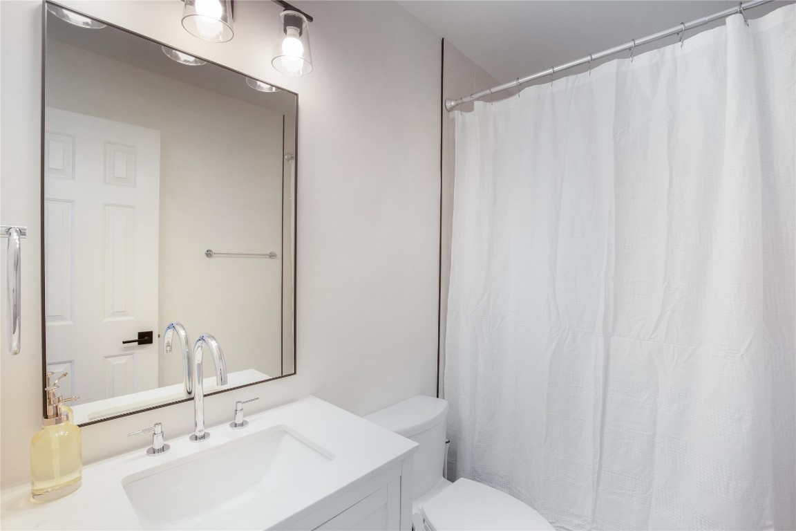 171 Hart Lane Dripping Springs, TX 78620 - Photo 22 of 40 a bathroom with a sink a toilet and shower