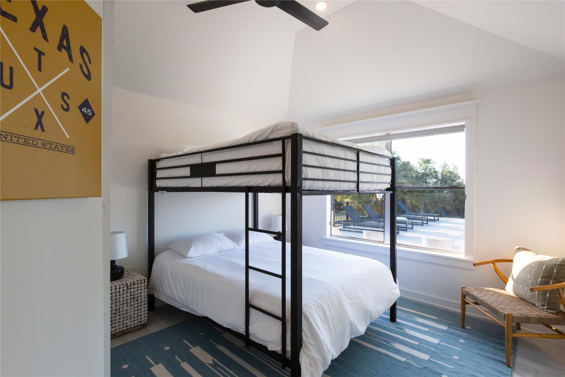 171 Hart Lane Dripping Springs, TX 78620 - Photo 23 of 40 a bedroom with a bed and wooden floor