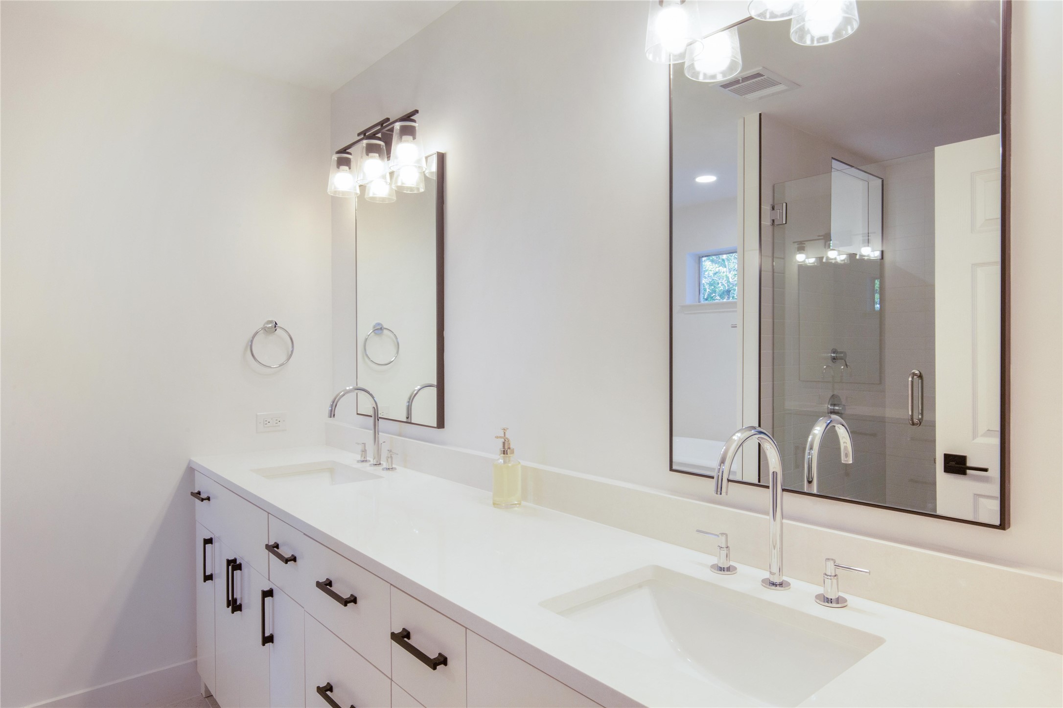 171 Hart Lane Dripping Springs, TX 78620 - Photo 26 of 40 a bathroom with double vanity sinks and a mirror