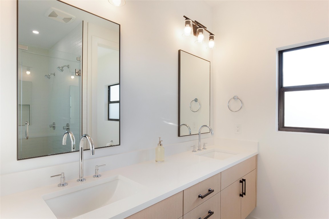171 Hart Lane Dripping Springs, TX 78620 - Photo 30 of 40 a bathroom with a double vanity sink mirror and next to a window