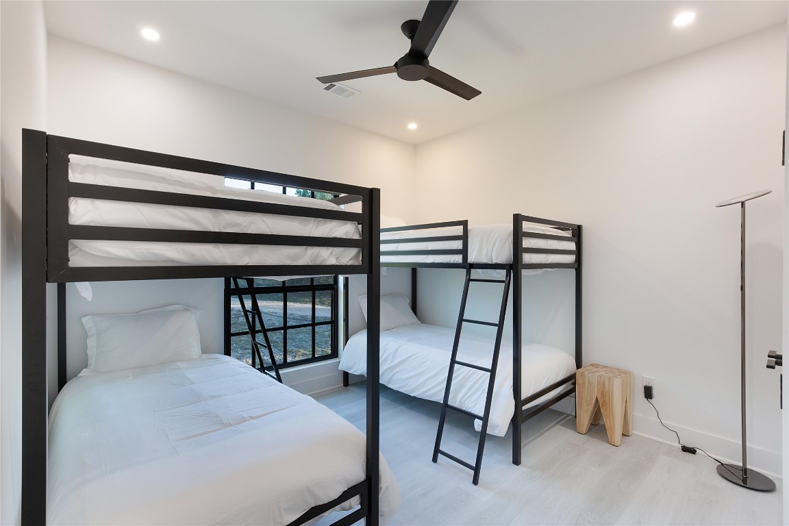 171 Hart Lane Dripping Springs, TX 78620 - Photo 32 of 40 a bedroom with a bed and a ceiling fan