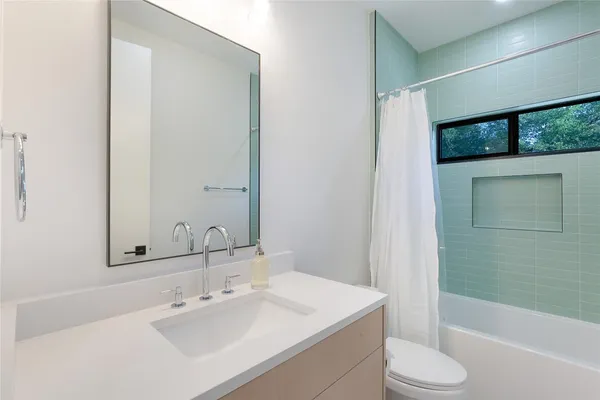 a bathroom with a sink toilet and shower