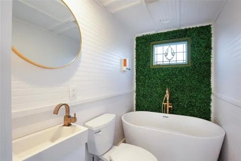 a bathroom with a toilet a sink and bathtub