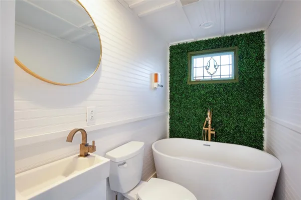 a bathroom with a toilet a sink and bathtub