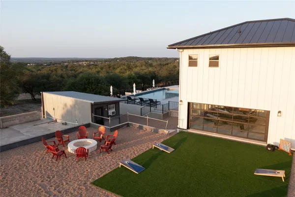 an aerial view of a house with backyard space and balcony