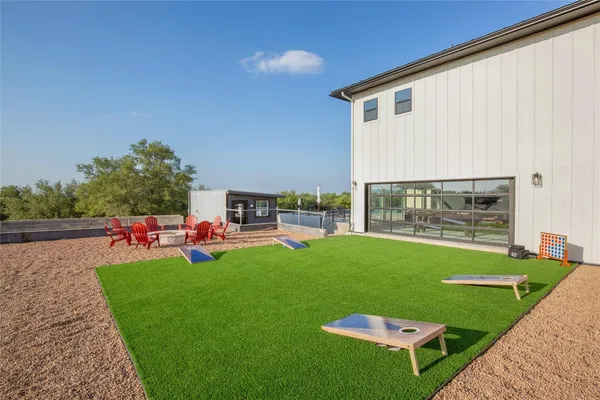 a view of a backyard with sitting area