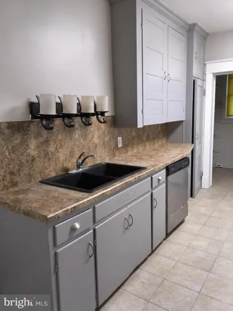 a kitchen with stainless steel appliances granite countertop a sink and white cabinets