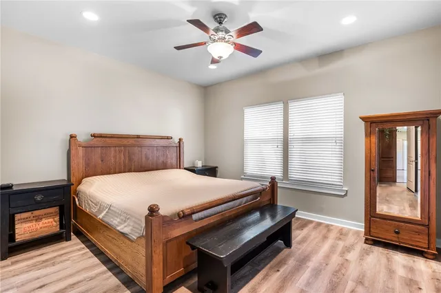 a bed sitting in a bedroom next to a window