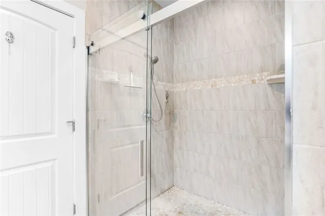 a bathroom with a glass shower door
