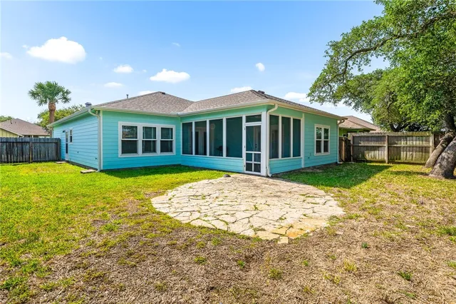 a view of a house with a swimming pool and a yard