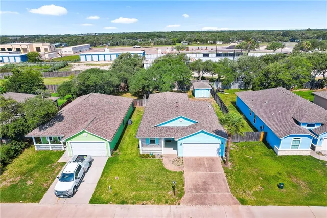 a aerial view of a house with yard swimming pool and outdoor seating
