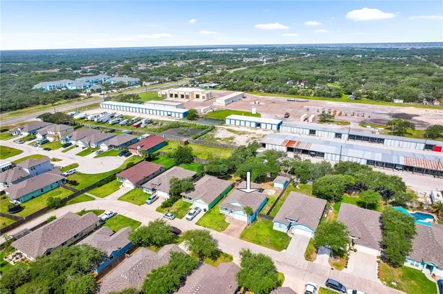 an aerial view of residential houses with outdoor space