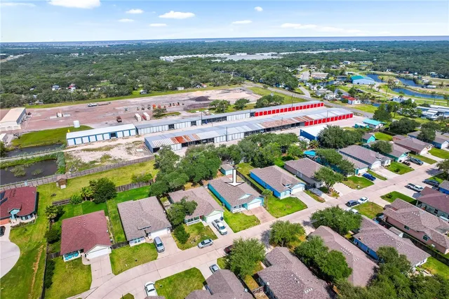 an aerial view of residential houses with outdoor space and street view