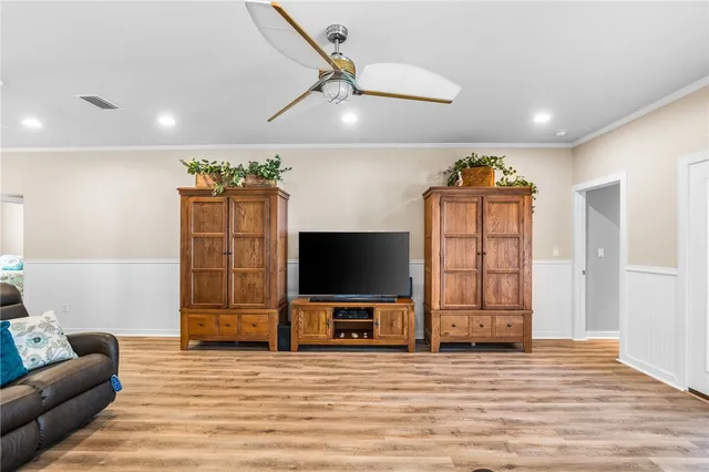 a view of a livingroom with furniture and a flat screen tv