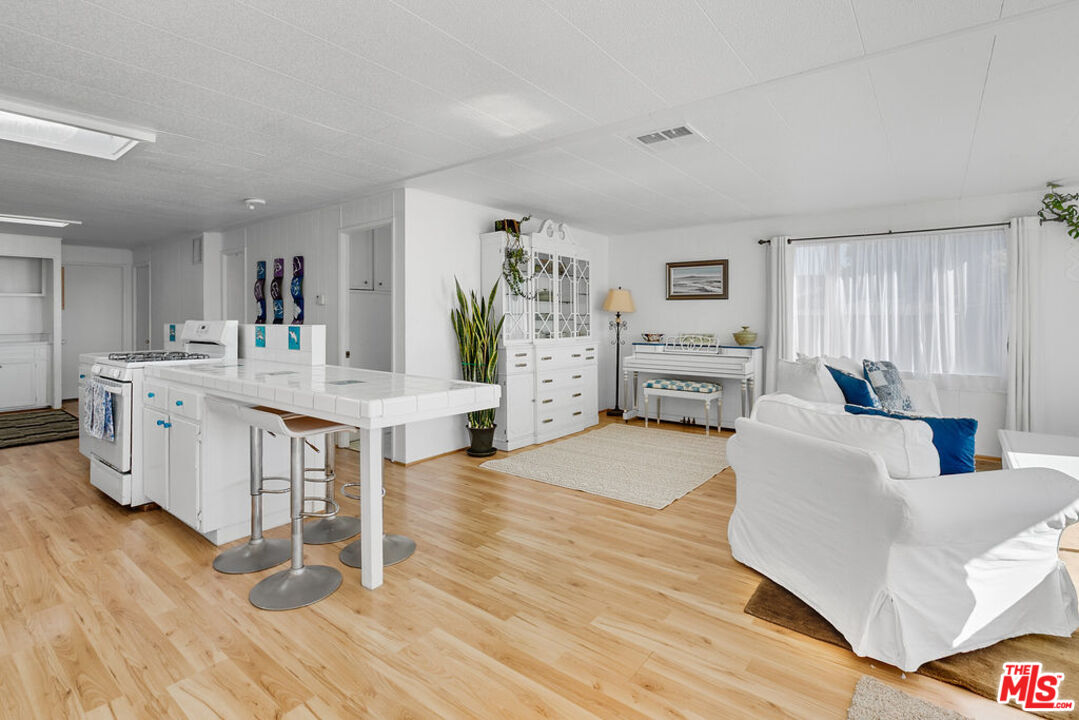 29500 Heathercliff Road, Unit 252 Malibu, CA 90265 - Photo 12 of 50 a living room with furniture and a wooden floor