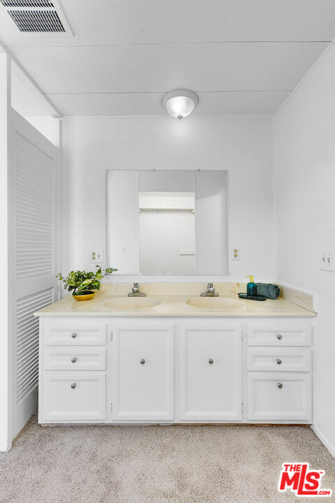 29500 Heathercliff Road, Unit 252 Malibu, CA 90265 - Photo 25 of 50 a bathroom with a granite countertop sink and a bathtub