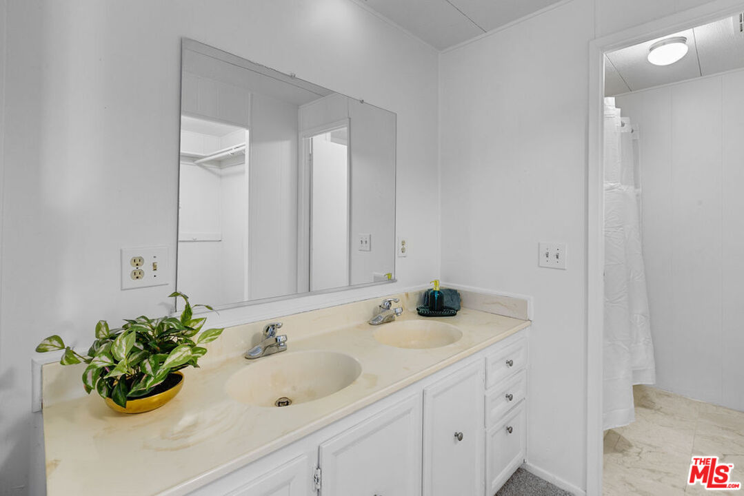 29500 Heathercliff Road, Unit 252 Malibu, CA 90265 - Photo 26 of 50 a bathroom with a sink and a mirror