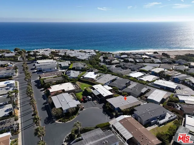 a kitchen with stainless steel appliances kitchen island granite countertop a stove and a wooden floors