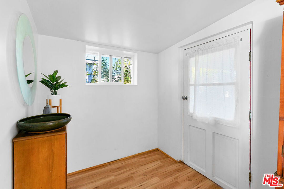 29500 Heathercliff Road, Unit 252 Malibu, CA 90265 - Photo 4 of 50 a view of empty room with window and wooden floor