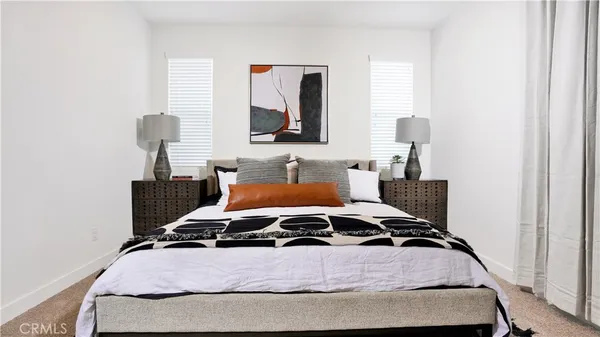 a bedroom with bed and window