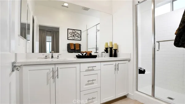 a bathroom with a double vanity sink and a mirror