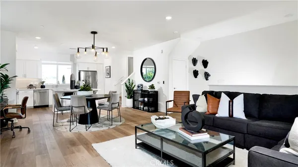 a living room with fireplace furniture and a wooden floor