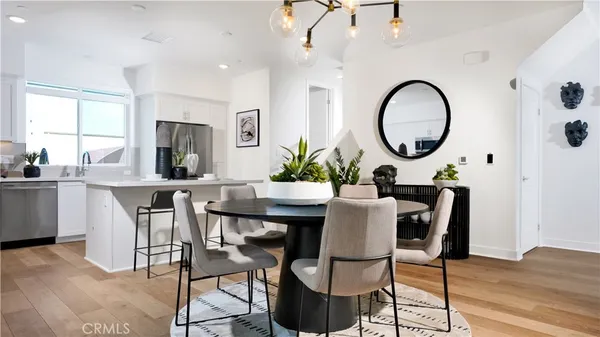 a dining room with furniture a window and wooden floor