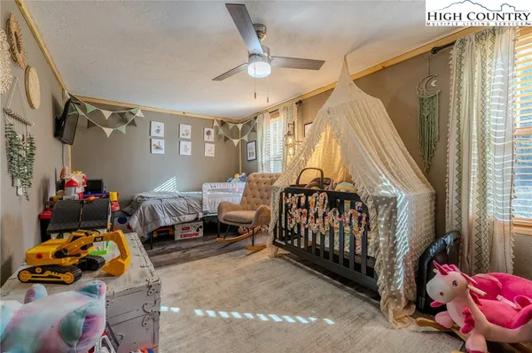 a bedroom with a large bed and a flat screen tv