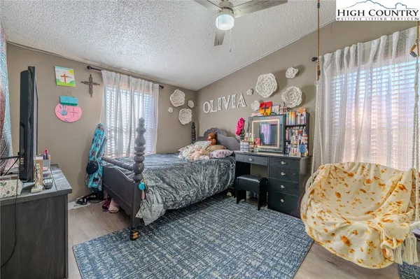 a bedroom with a bed dresser and a window