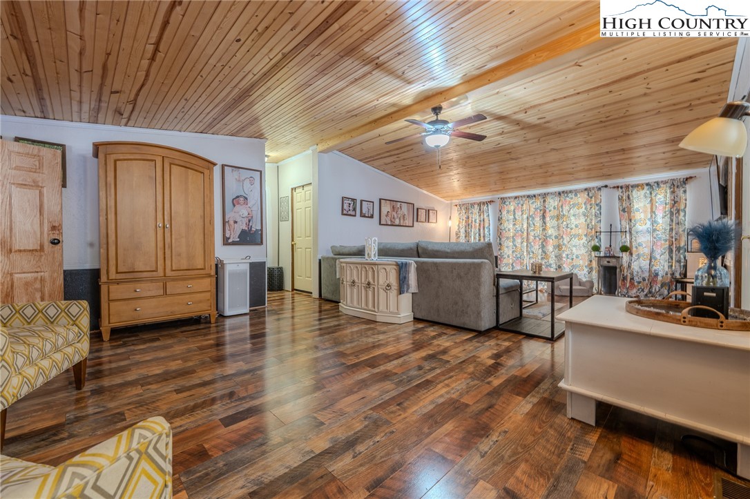 672 Upper Hanging Rock Road Spruce Pine, NC 28777 - Photo 20 of 22 a living room with furniture and a wooden floor
