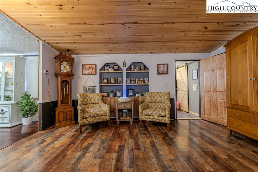 672 Upper Hanging Rock Road Spruce Pine, NC 28777 - Photo 7 of 22 a spacious bedroom with a bed and a couch