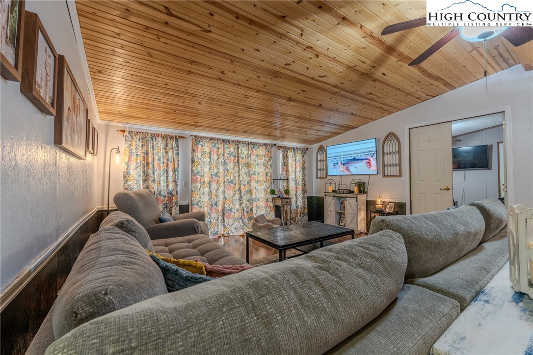 672 Upper Hanging Rock Road Spruce Pine, NC 28777 - Photo 8 of 22 a living room with furniture and a large window