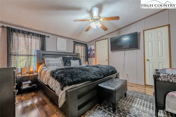 a bedroom with a bed and a chandelier